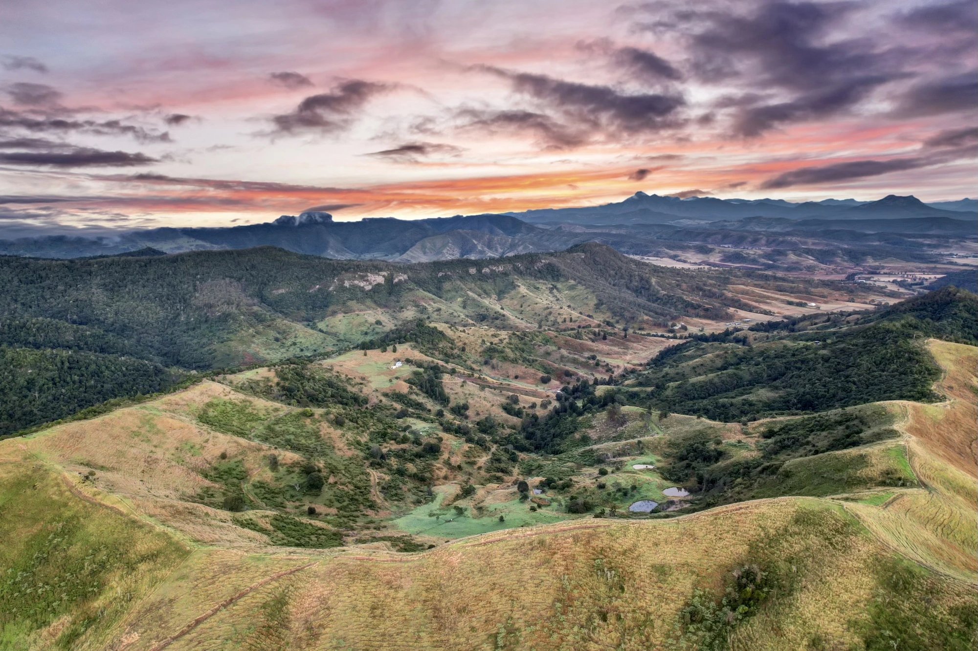 Aerial view over the ridges and valleys of Greenhollow at sunrise